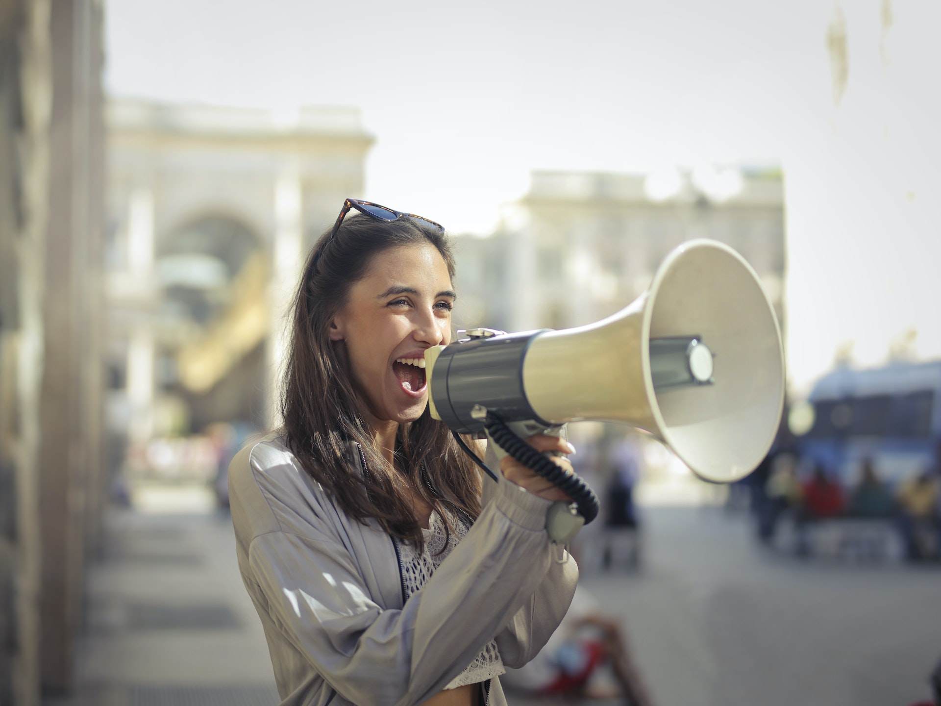 young woman shouting into a megaphone