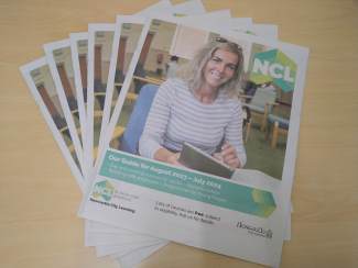A pile of copies of Newcastle City Learning's 2023/24 brochure