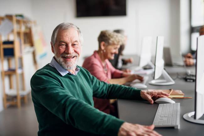 man taking part in lifelong learning computer class